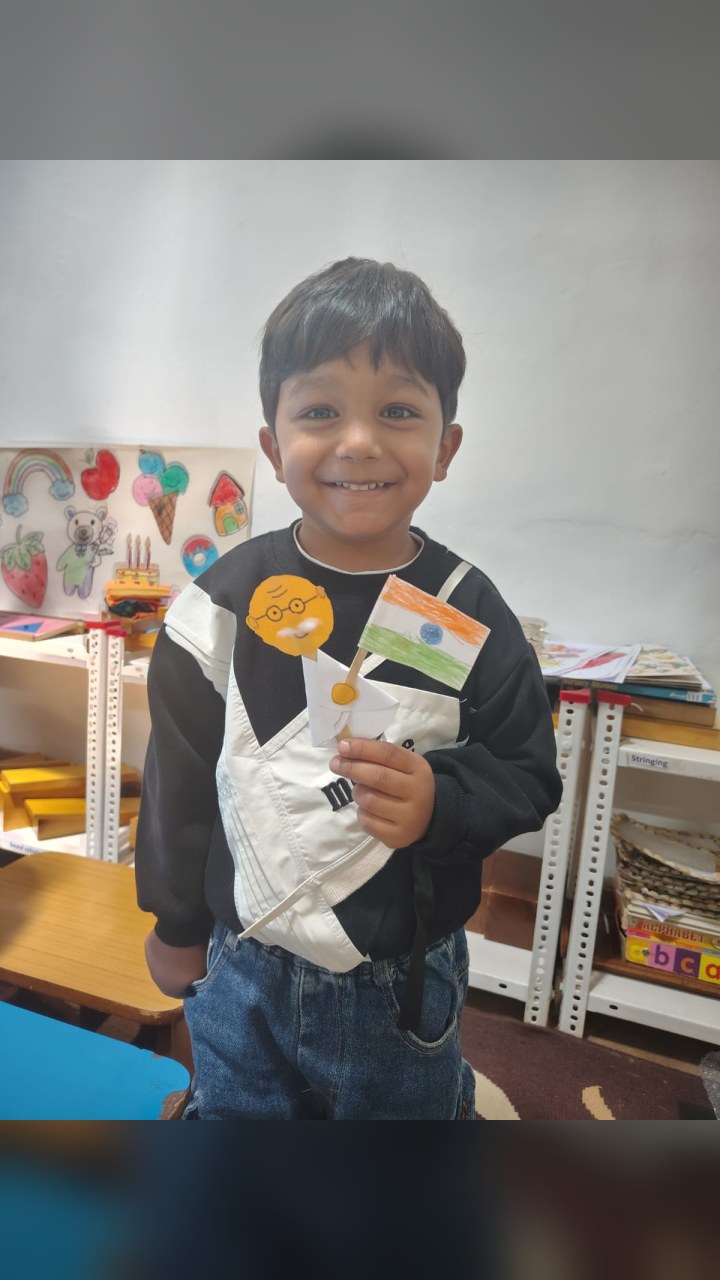 A BMS student holding a paper craft made for Gandhi Jayanti