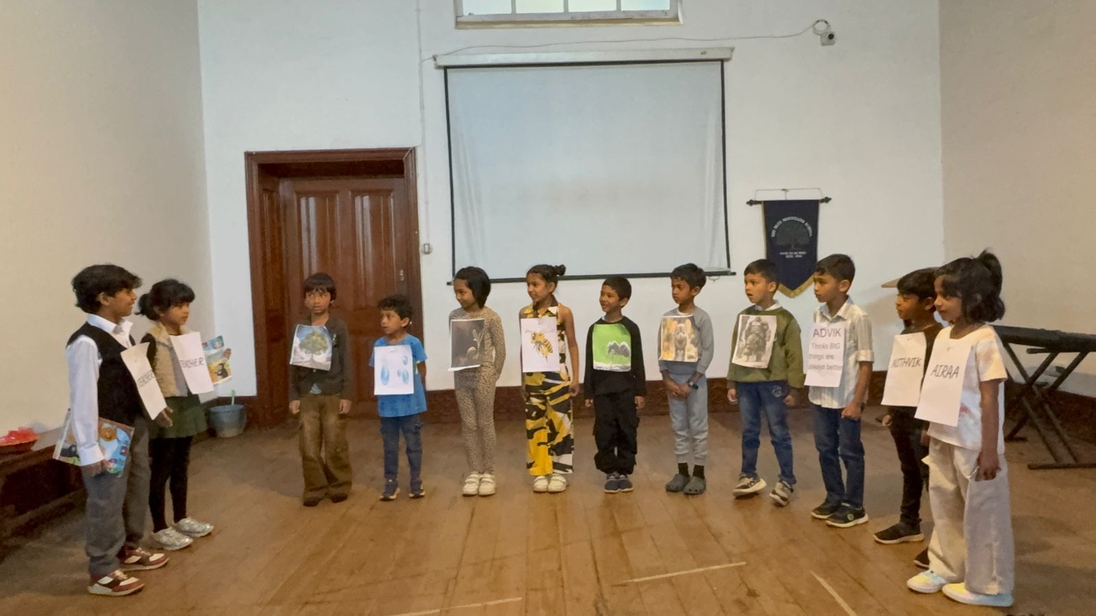 Two students dressed as teachers join the cast, holding storybooks