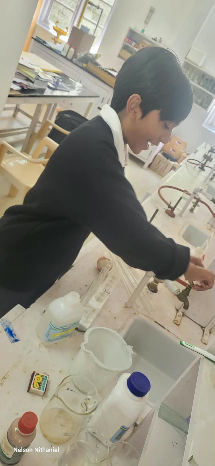 A student adjusting the focus at the laboratory bench